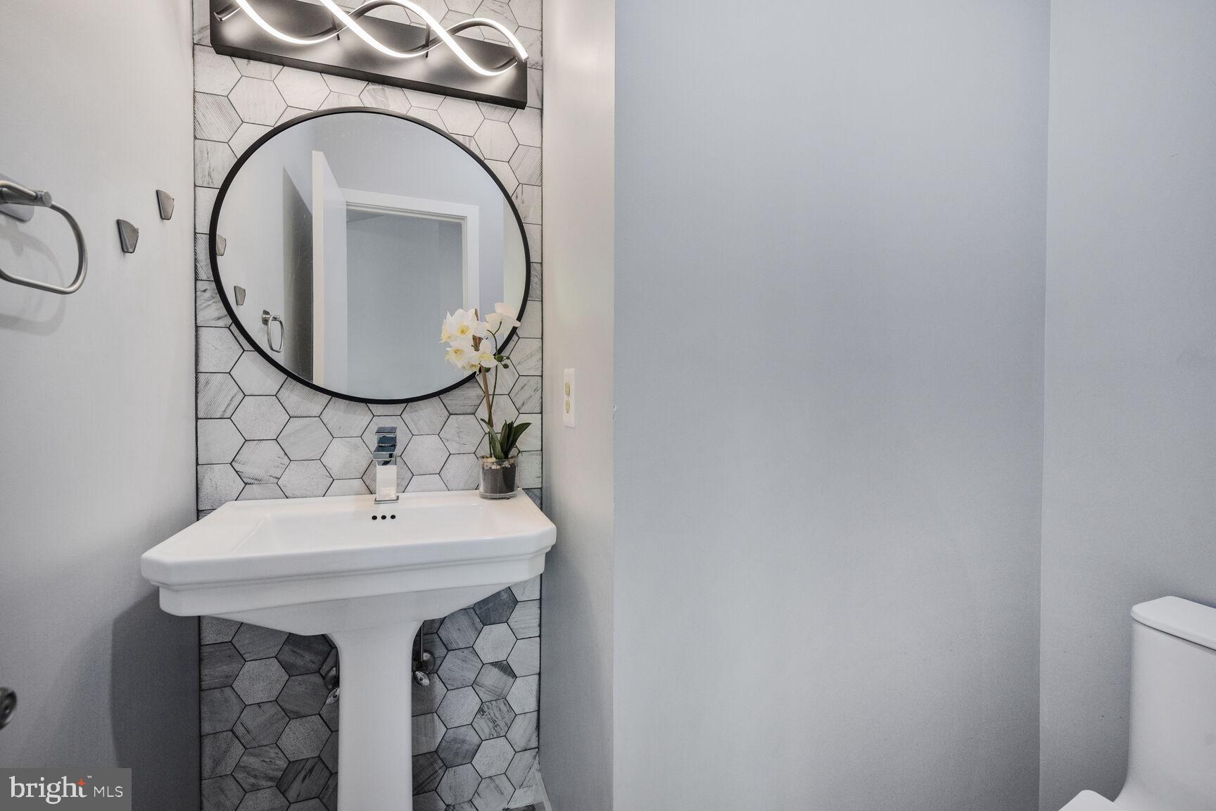 7816 Laurel Leaf Drive Potomac, MD 20854 - Photo 13 of 31 a bathroom with a sink and a mirror