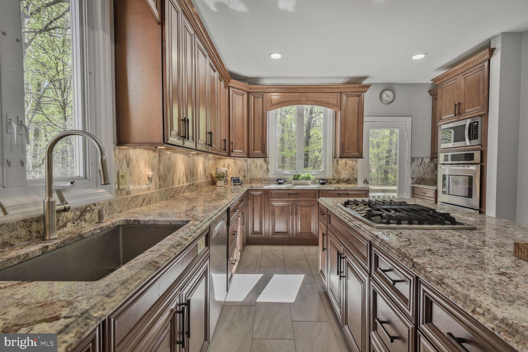 7816 Laurel Leaf Drive Potomac, MD 20854 - Photo 9 of 31 a kitchen with stainless steel appliances granite countertop a sink stove and cabinets