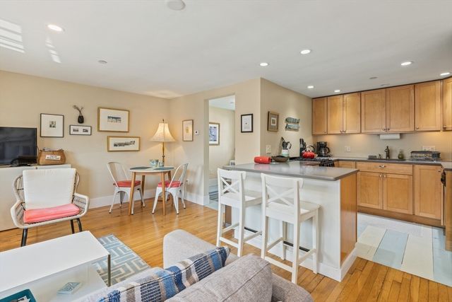 a living room with furniture a dining table and kitchen view