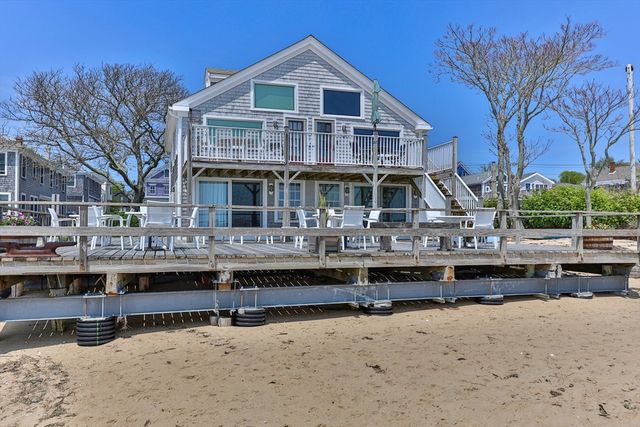 a view of a patio with table and chairs under an umbrella