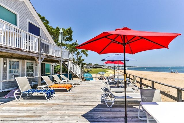 a view of a rooftop deck with couch and chairs
