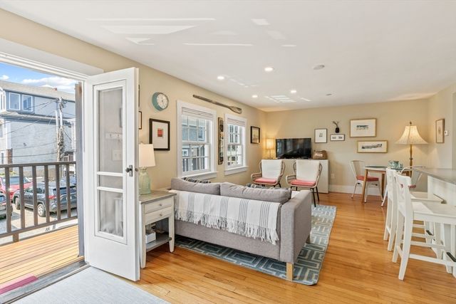 a kitchen with white cabinets and sink