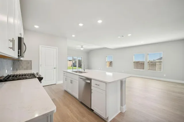 a kitchen with a sink and cabinets