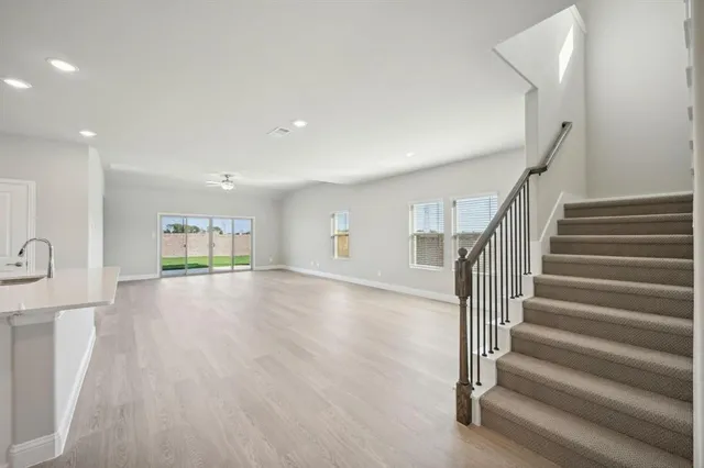 a view of entryway and hall with wooden floor