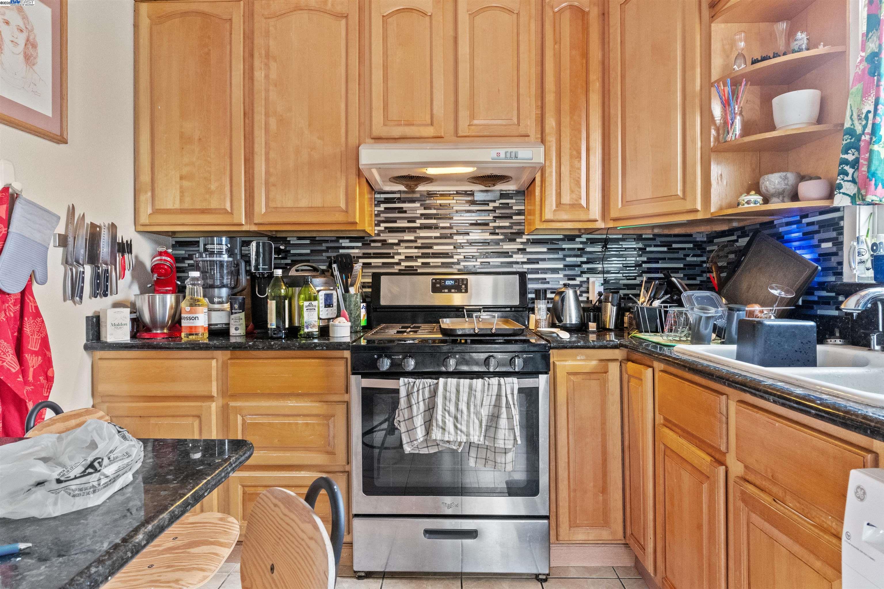 1523 Lincoln Avenue Alameda, CA 94501 - Photo 13 of 32 a kitchen with stainless steel appliances granite countertop a stove and cabinets