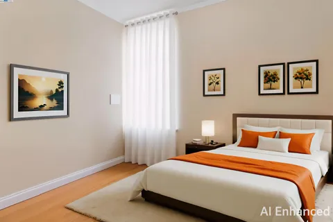 a bedroom with a bed and painting on the wall