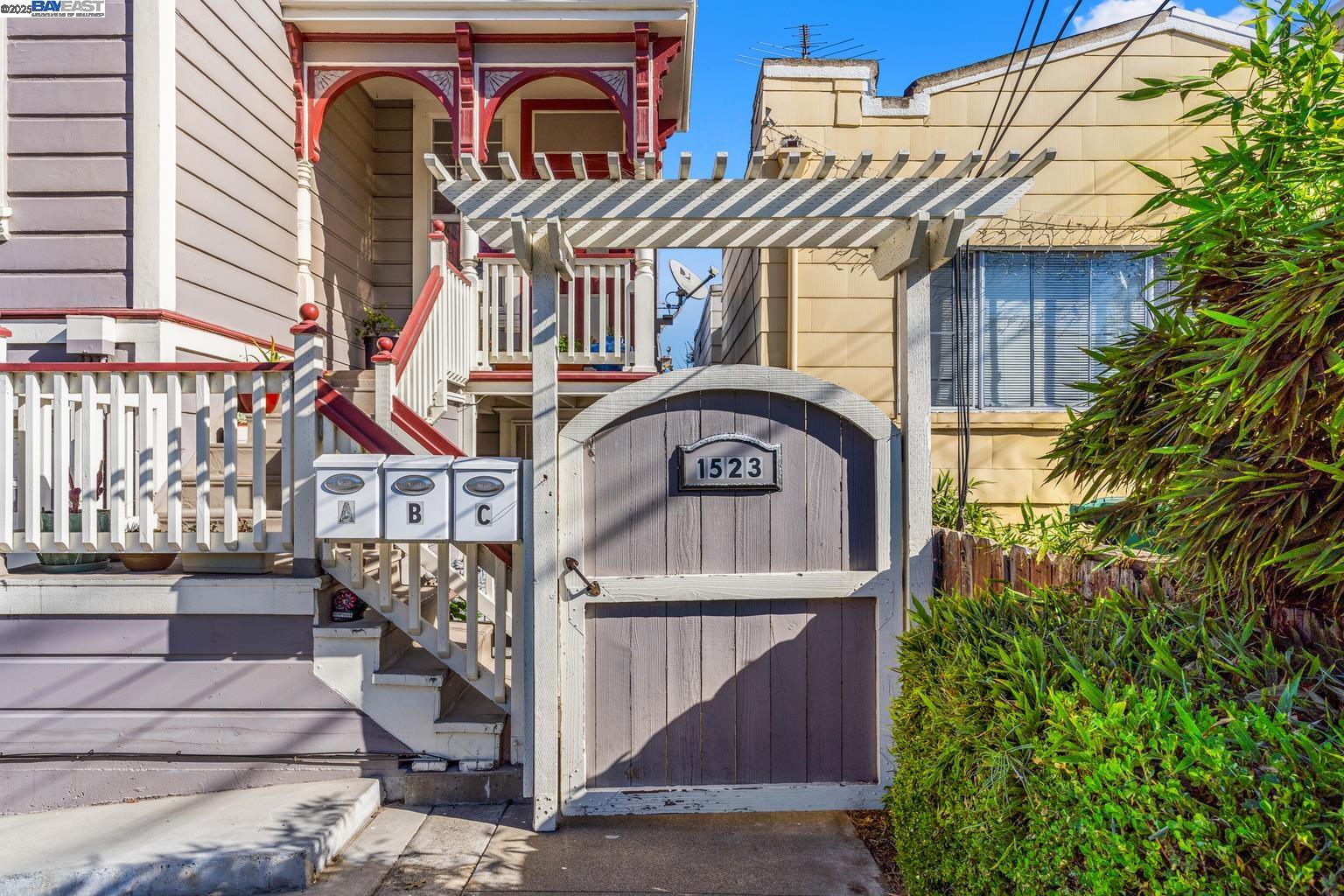 1523 Lincoln Avenue Alameda, CA 94501 - Photo 2 of 32 a view of a brick house with plants and wooden fence