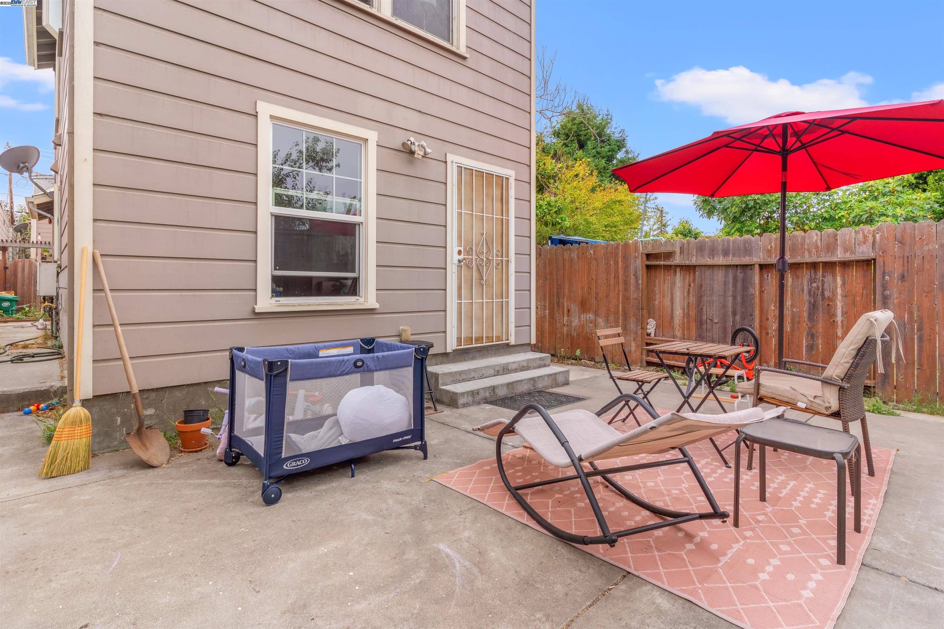 1523 Lincoln Avenue Alameda, CA 94501 - Photo 23 of 32 a view of a patio with a table and chairs under an umbrella