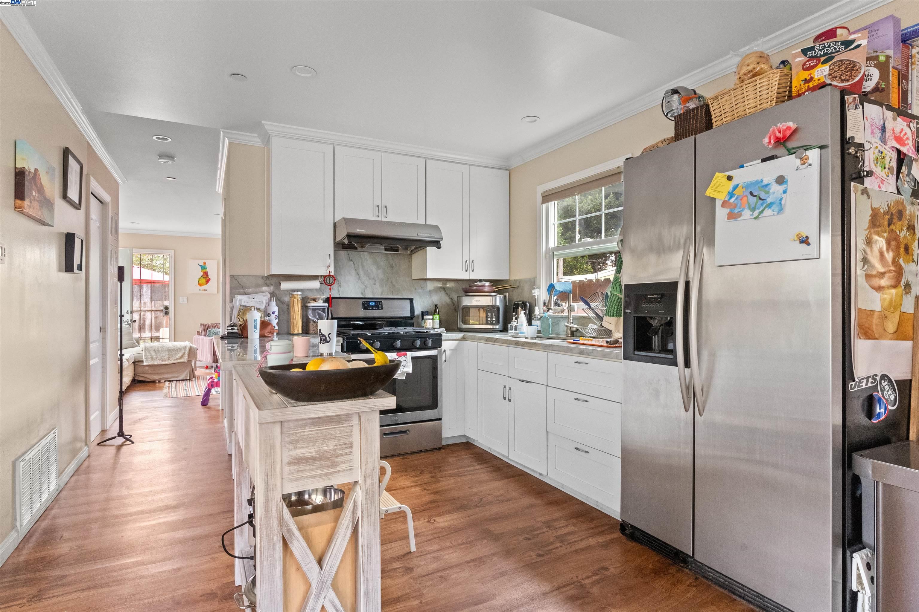 1523 Lincoln Avenue Alameda, CA 94501 - Photo 4 of 32 a kitchen with stainless steel appliances a stove a refrigerator a sink a dining table and chairs