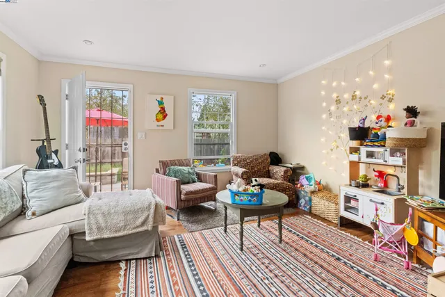 a living room with furniture and a book shelf