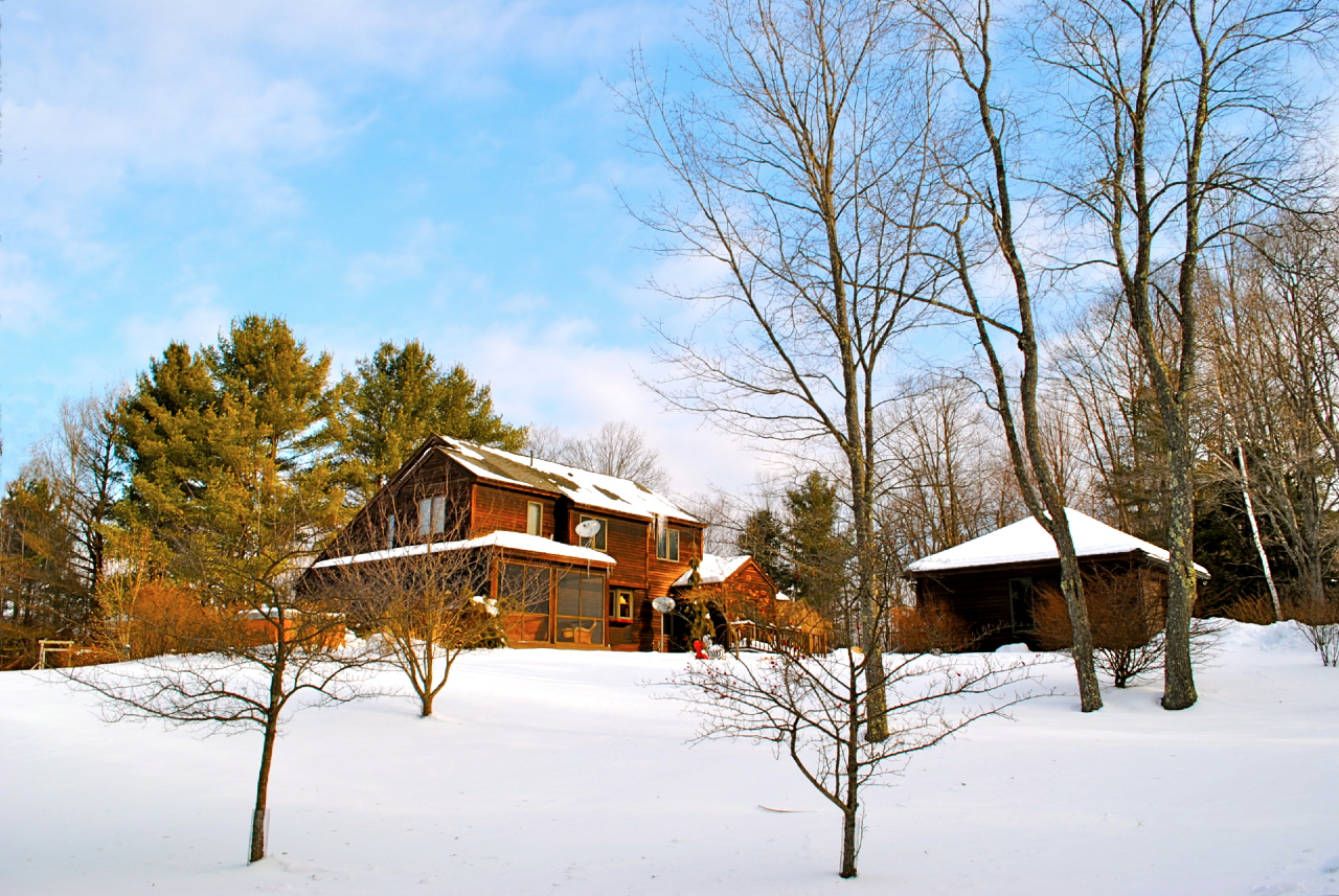 a view of a house with snow on the road
