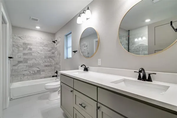 a bathroom with a sink a toilet and a mirror