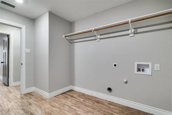 a view of room with wooden floor