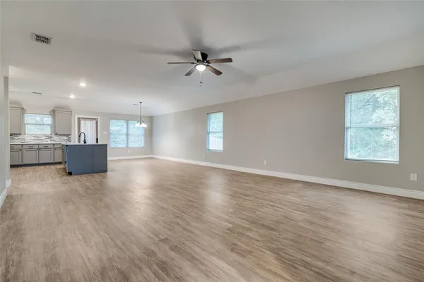 a view of kitchen and hall with wooden floor and a kitchen