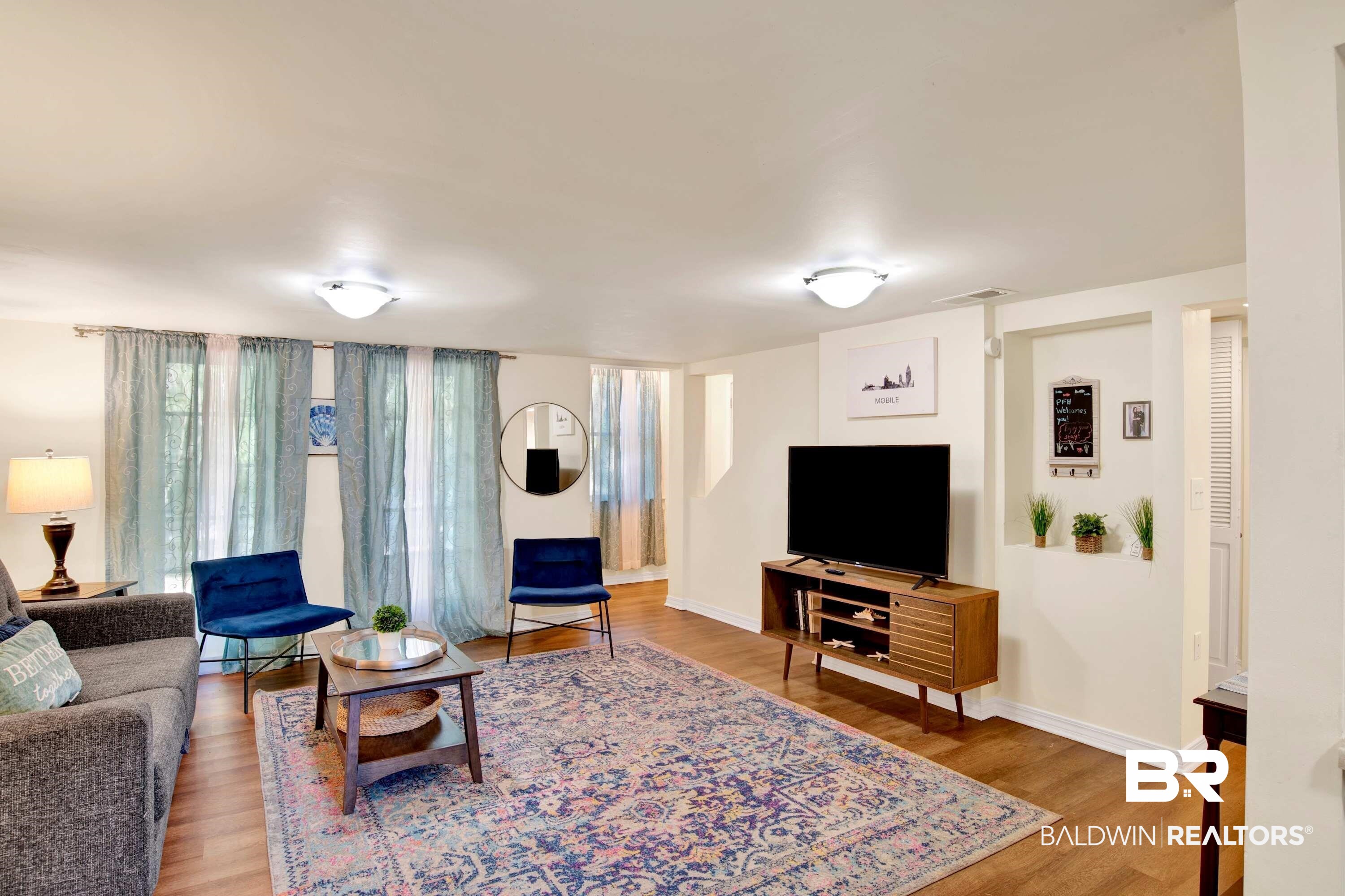 1141 Montauk Avenue Mobile, AL 36604 - Photo 7 of 15 Living area with baseboards, visible vents, and wood finished floors