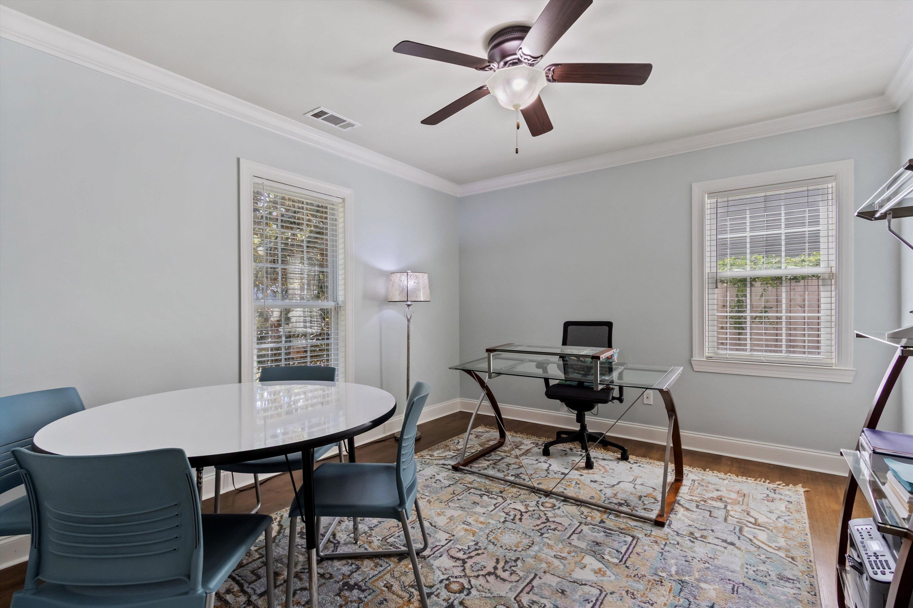 5302 South Angela Road Memphis, TN 38120 - Photo 24 of 40 Room with light blue walls, two windows with blinds, dark wood-finish flooring, and crown molding