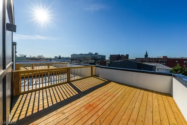 a view of balcony with wooden floor and city view