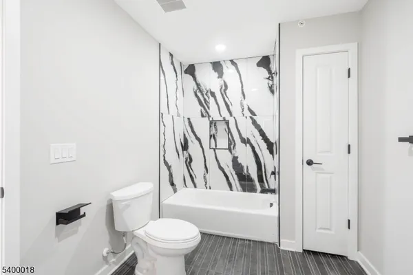 a bathroom with a toilet and a bathtub