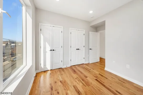 a view of room with window and wooden floor