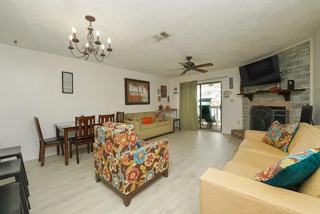 a living room with fireplace furniture and a flat screen tv
