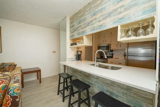 a view of a kitchen with a sink and dishwasher