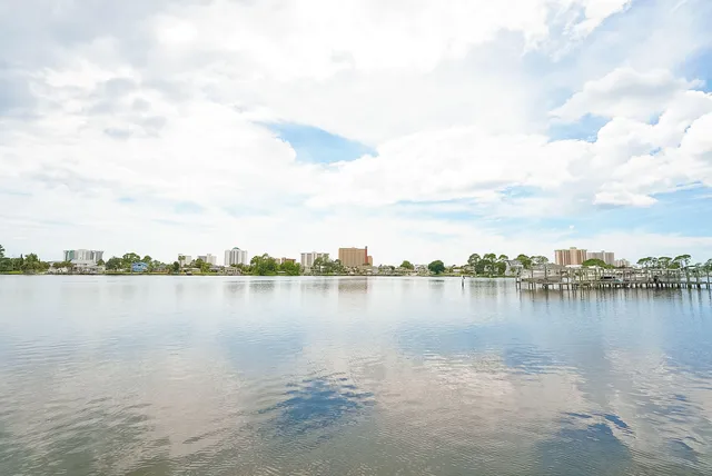 a view of a lake with houses in the back