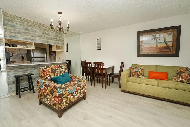 a living room with furniture and a chandelier