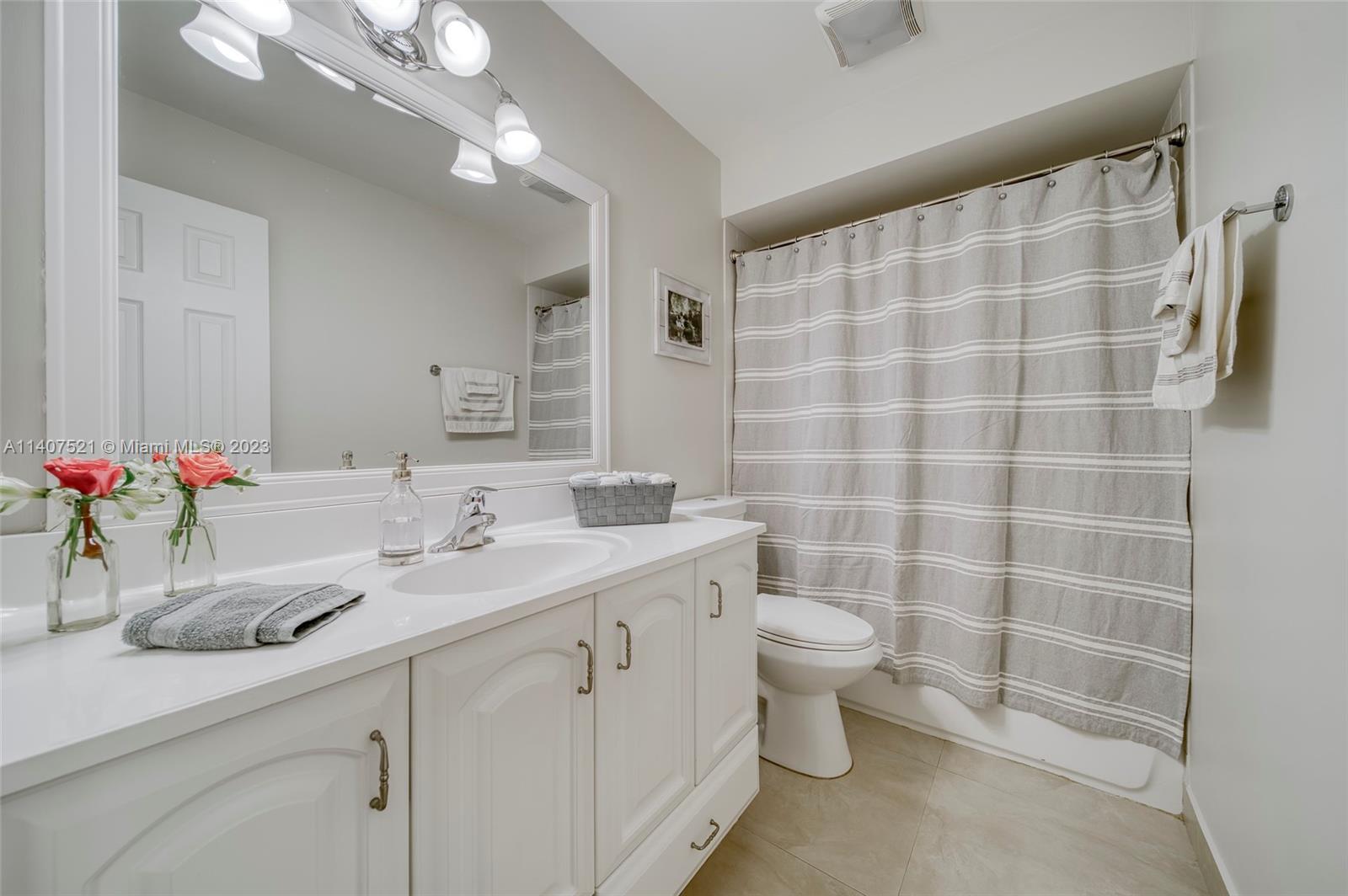 13401 Southwest 79th Street Miami, FL 33183 - Photo 17 of 34 a bathroom with a double vanity sink toilet and a mirror