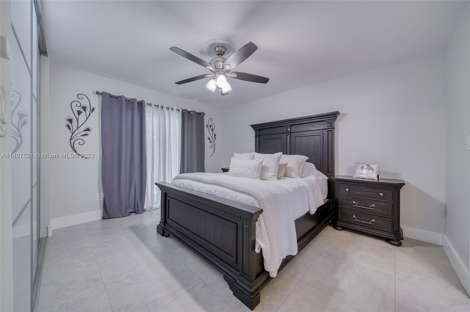 13401 Southwest 79th Street Miami, FL 33183 - Photo 18 of 34 a spacious bedroom with a bed and a chandelier