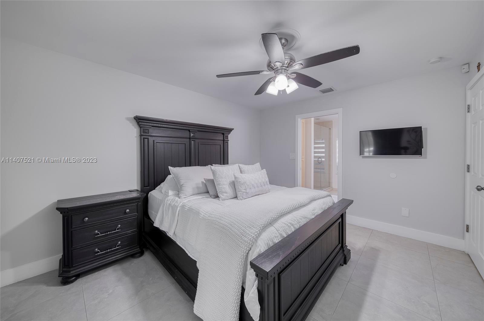 13401 Southwest 79th Street Miami, FL 33183 - Photo 19 of 34 a bedroom with a bed and a flat tv screen on dresser
