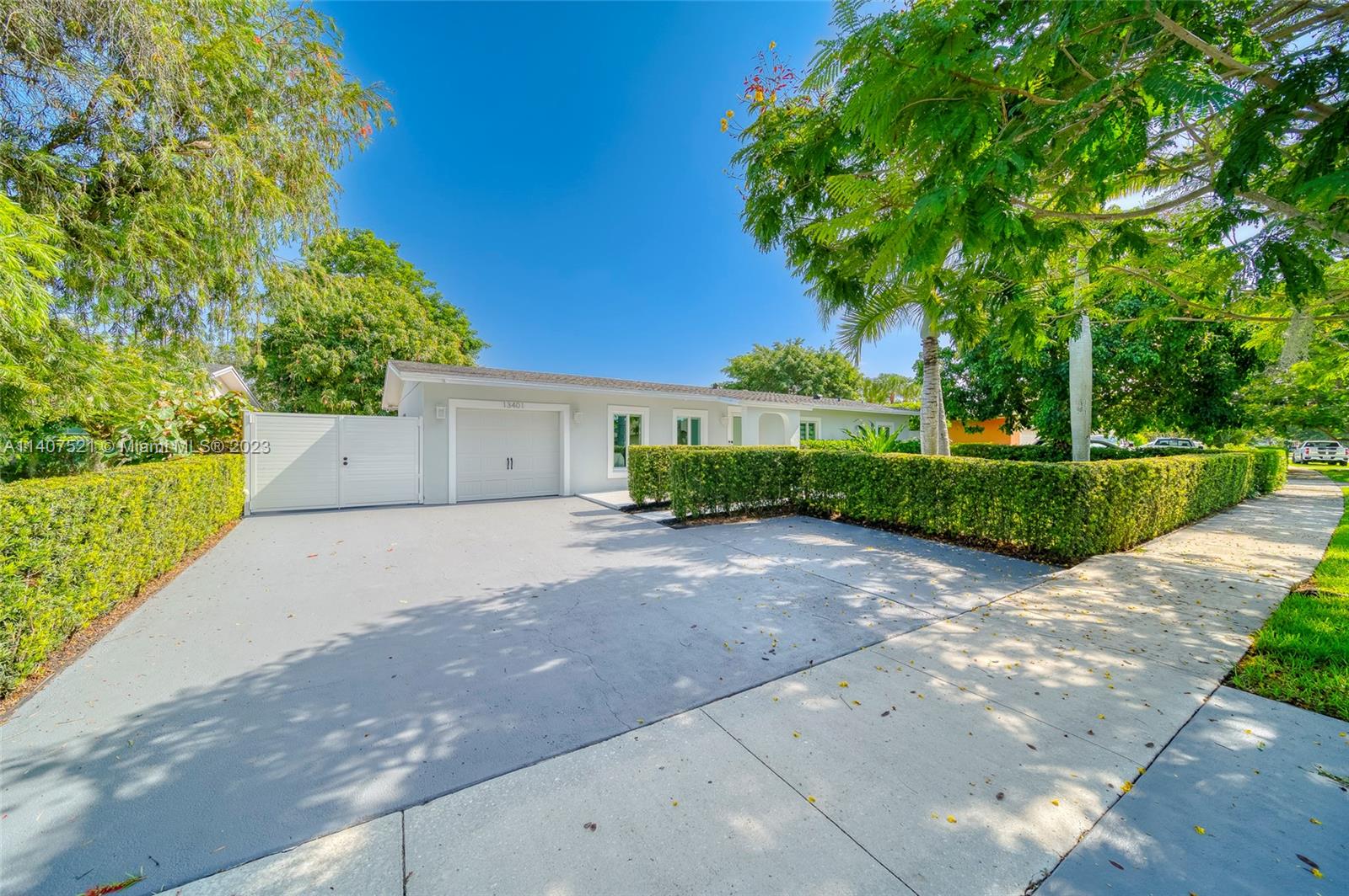 13401 Southwest 79th Street Miami, FL 33183 - Photo 3 of 34 a view of a house with a yard and garage