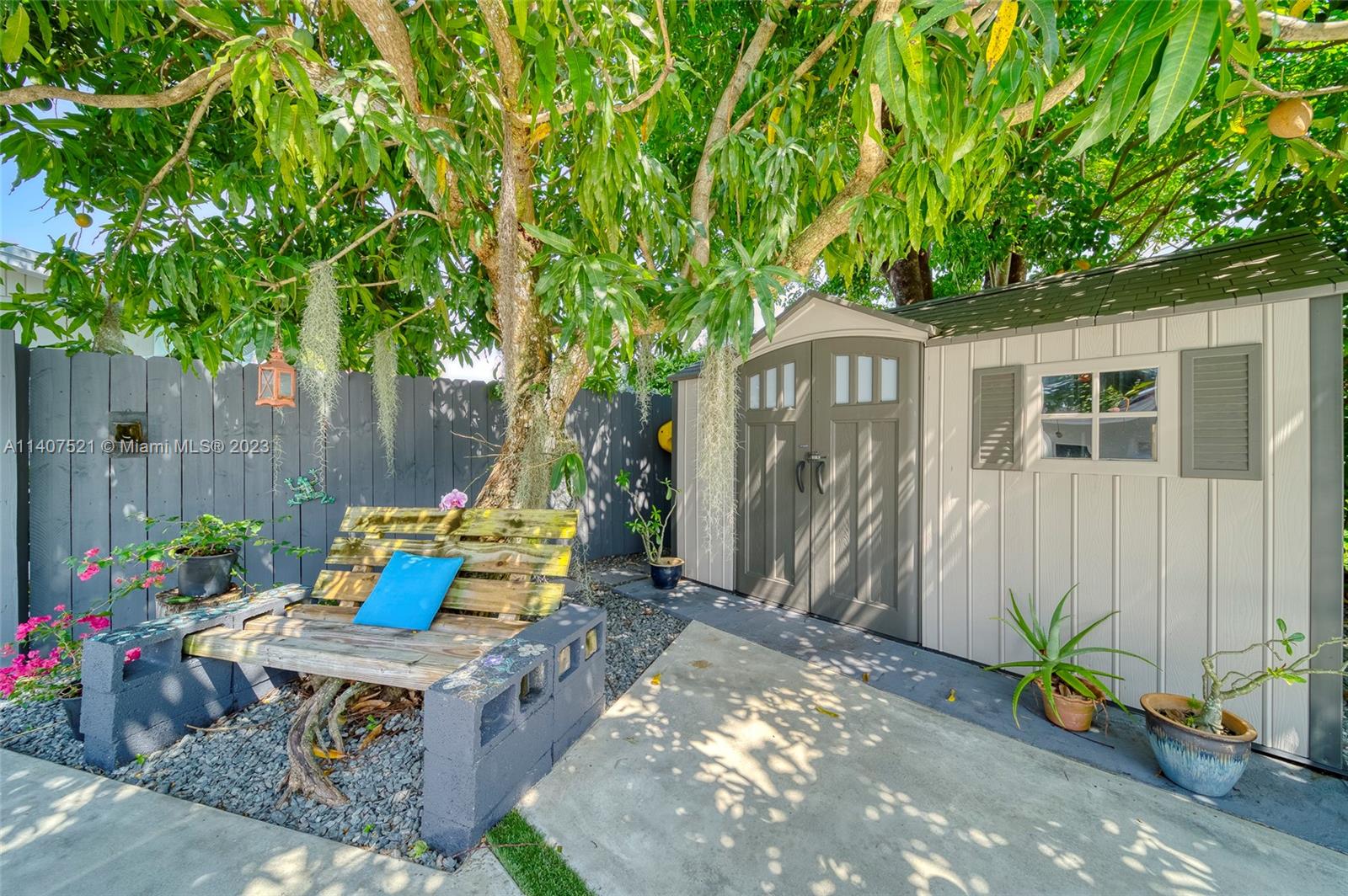 13401 Southwest 79th Street Miami, FL 33183 - Photo 32 of 34 a backyard of a house with table and chairs plants