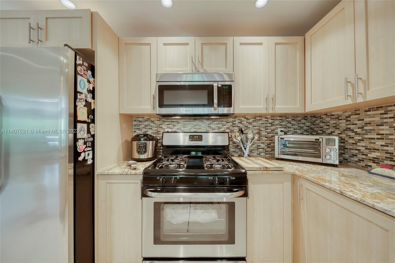 13401 Southwest 79th Street Miami, FL 33183 - Photo 9 of 34 a kitchen with stainless steel appliances granite countertop white cabinets a stove top oven and sink