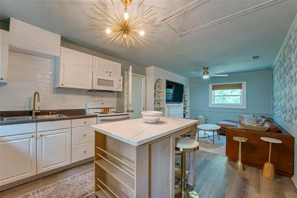 a kitchen that has a sink and a stove in it