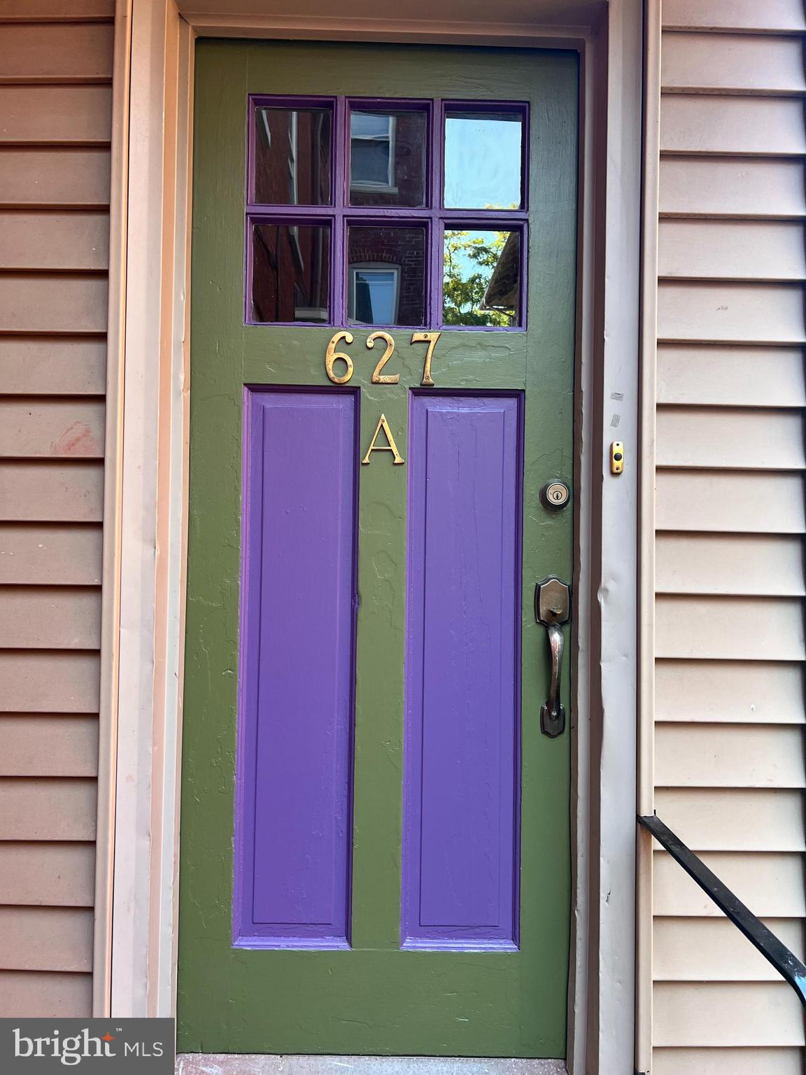 a view of a brick building with a red door