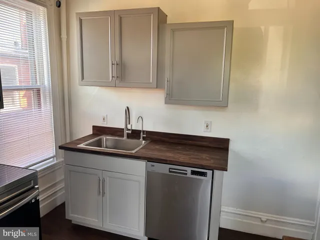a kitchen with stainless steel appliances granite countertop white cabinets and a granite counter tops