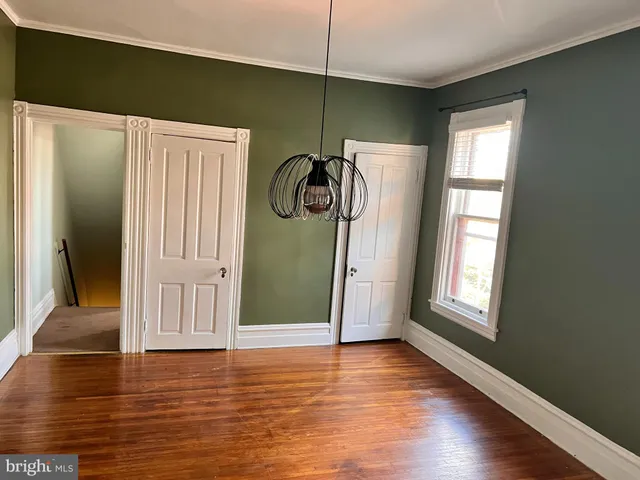 a view of an entryway with wooden floor