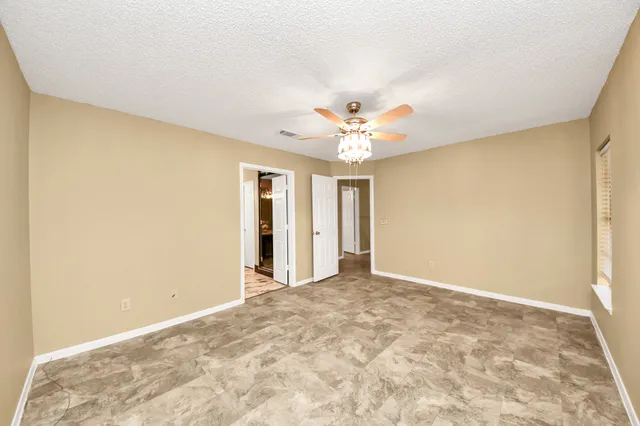 a view of an empty room with a chandelier