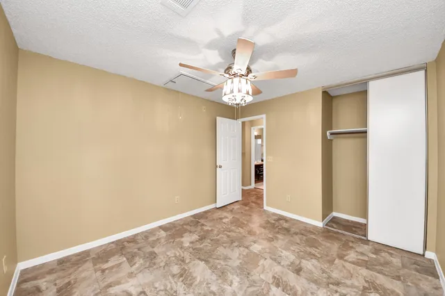 a view of a livingroom with a chandelier fan