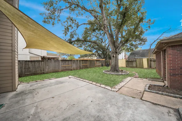 a view of a yard with a wooden fence