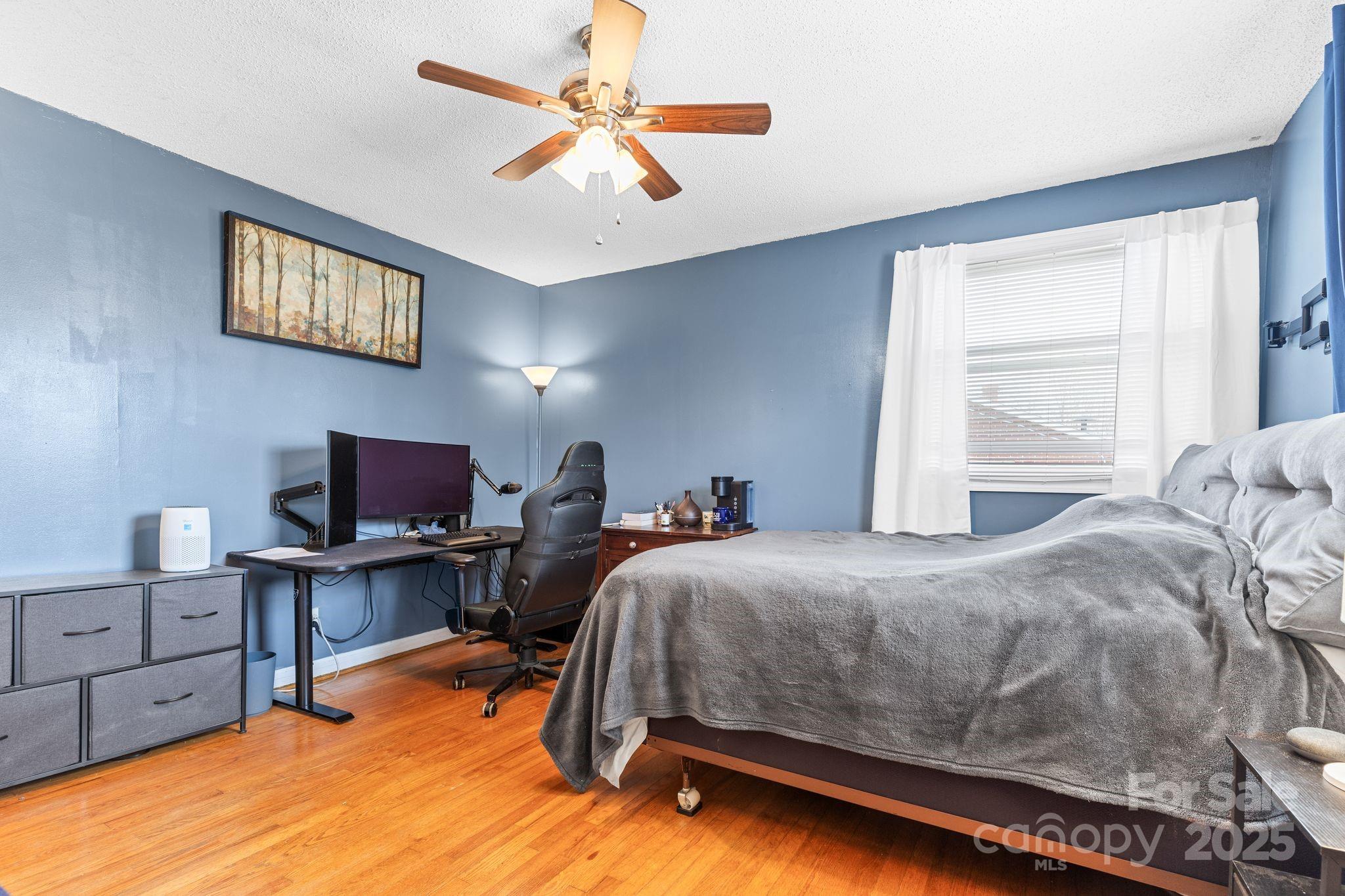 232 Hartness Road Statesville, NC 28677 - Photo 12 of 23 a bedroom with a bed workspace and a window