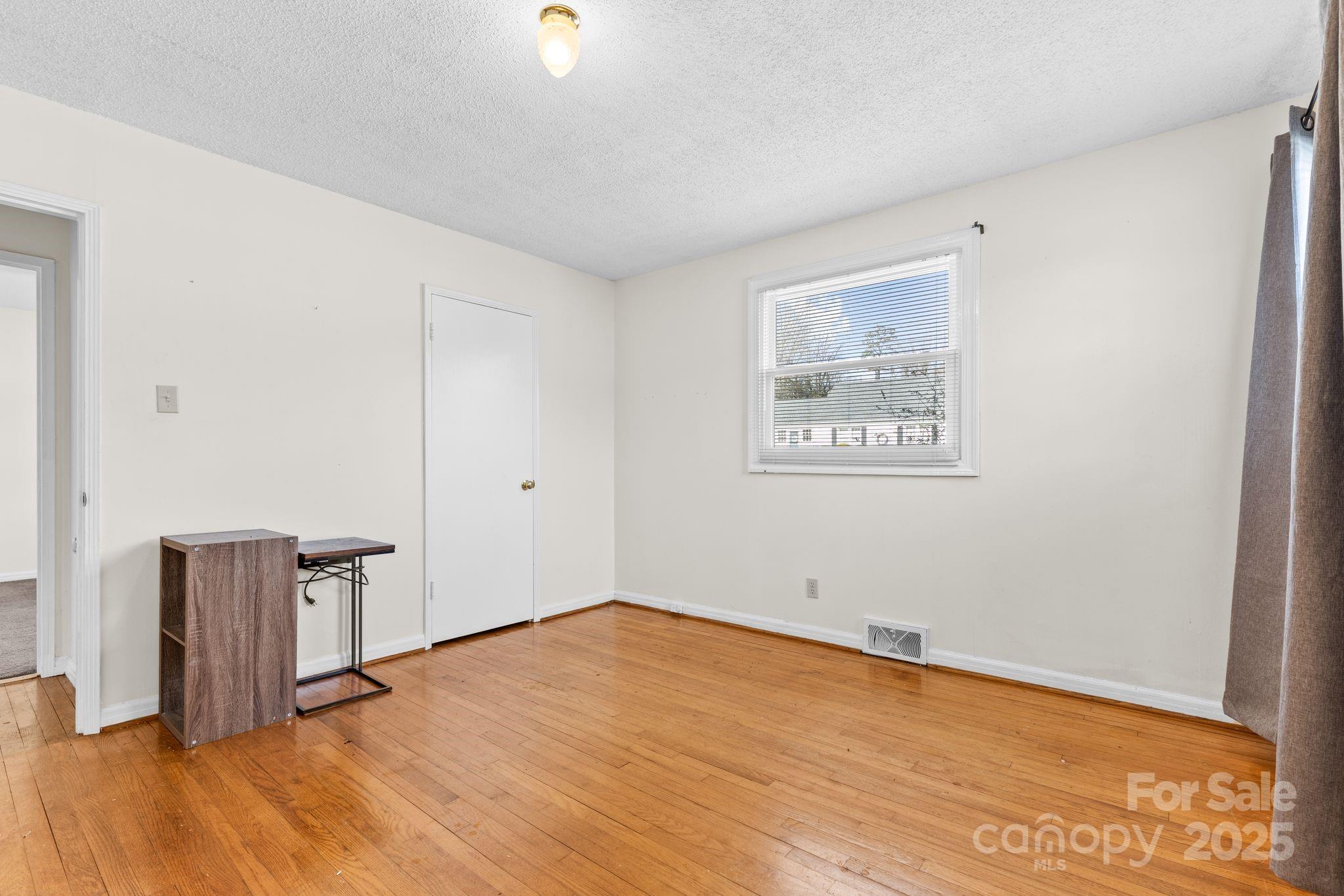 232 Hartness Road Statesville, NC 28677 - Photo 14 of 23 an empty room with wooden floor and windows