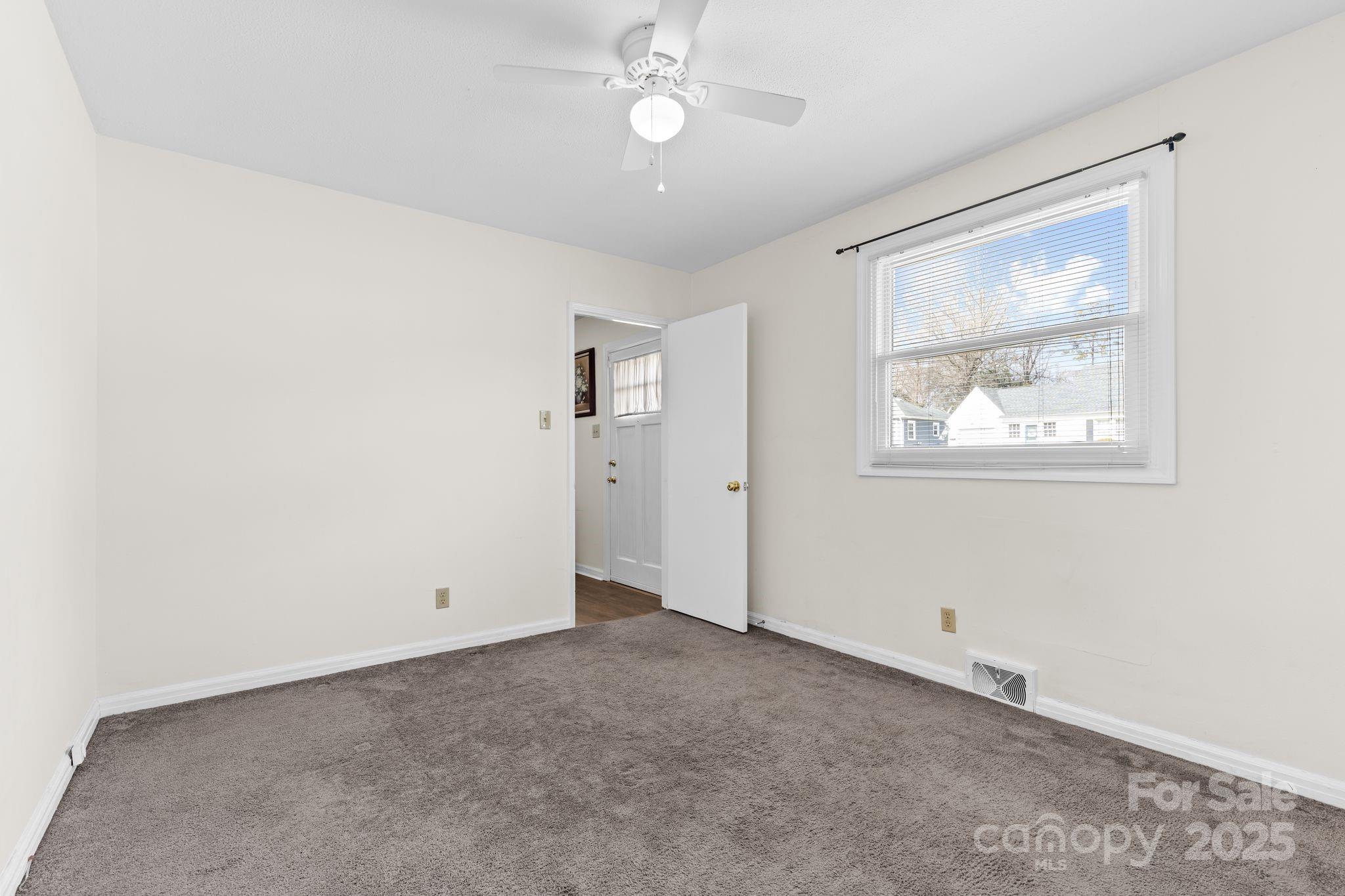232 Hartness Road Statesville, NC 28677 - Photo 15 of 23 an empty room with a window and a fan
