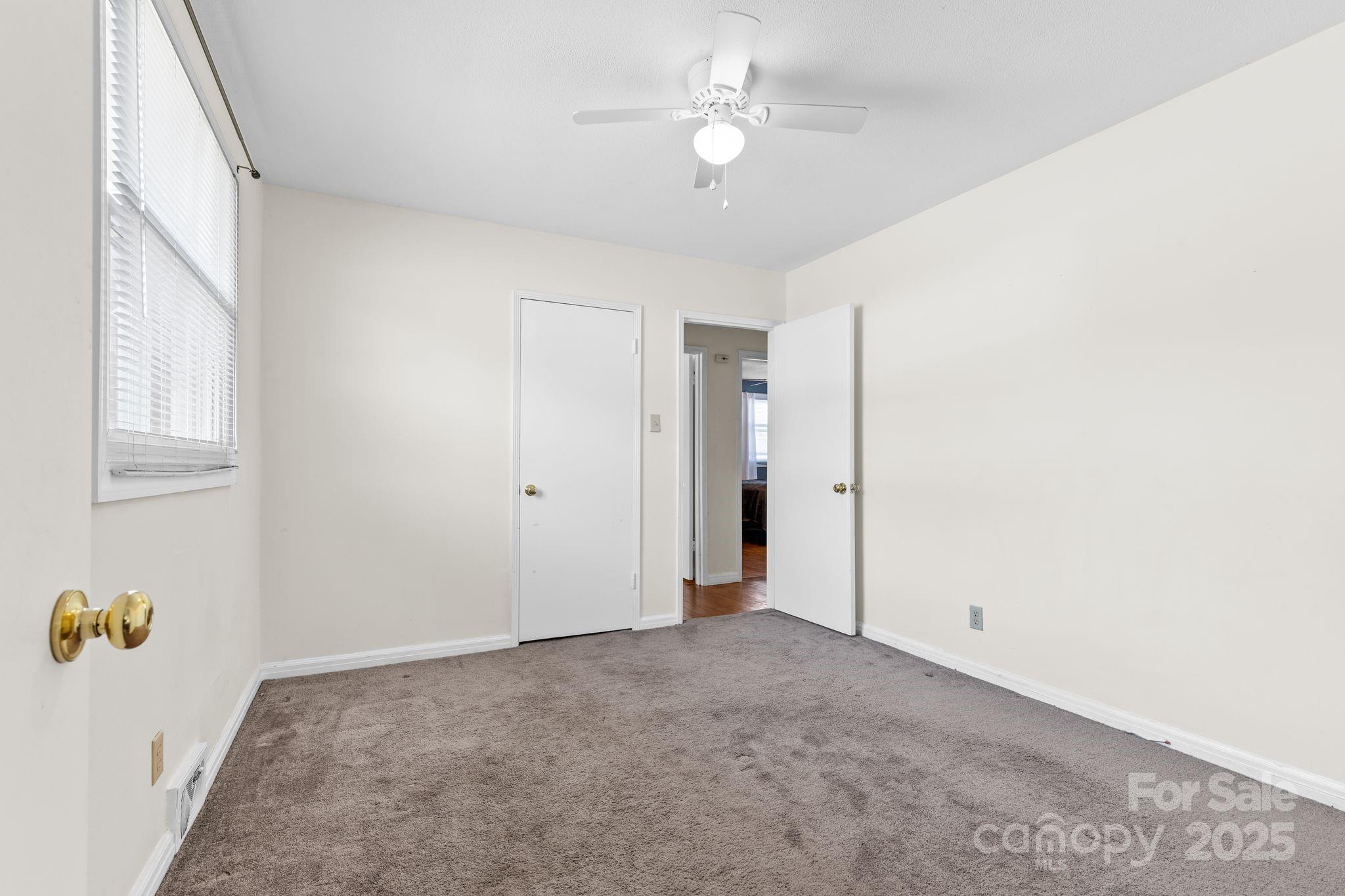 232 Hartness Road Statesville, NC 28677 - Photo 16 of 23 a view of an empty room with a chandelier fan