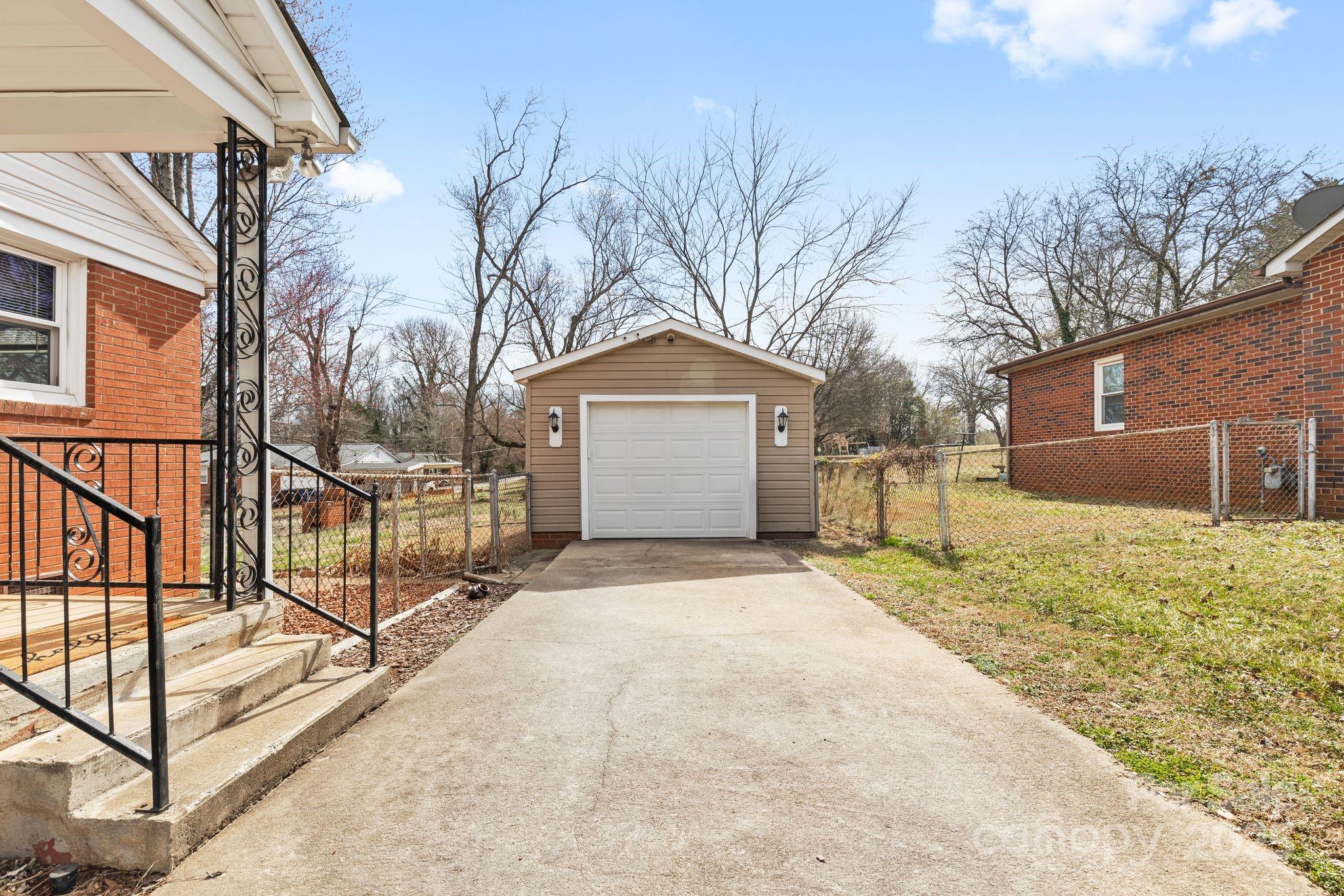 232 Hartness Road Statesville, NC 28677 - Photo 21 of 23 a front view of a house with a yard and garage