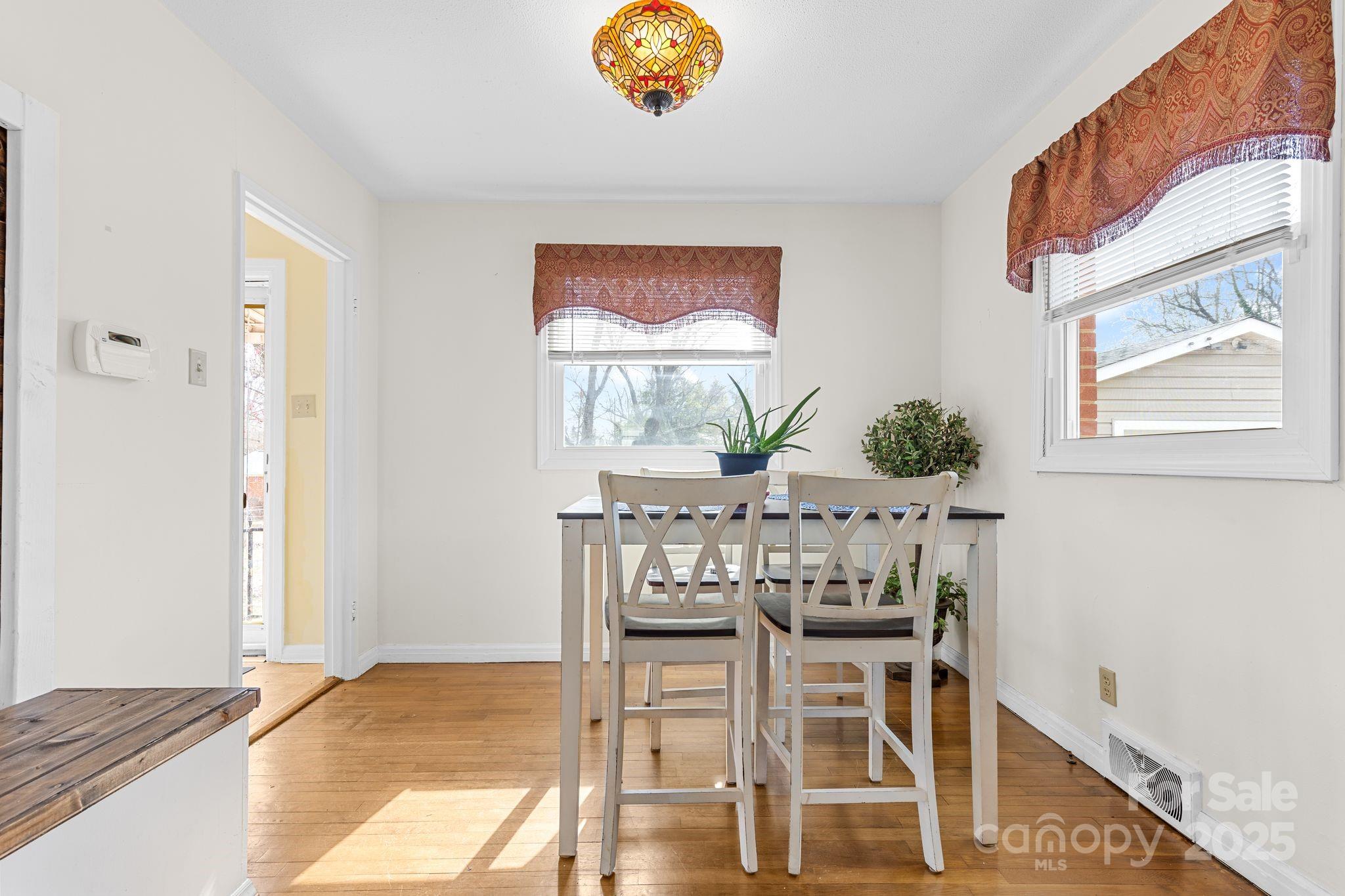 232 Hartness Road Statesville, NC 28677 - Photo 7 of 23 a view of a dining room with furniture and wooden floor