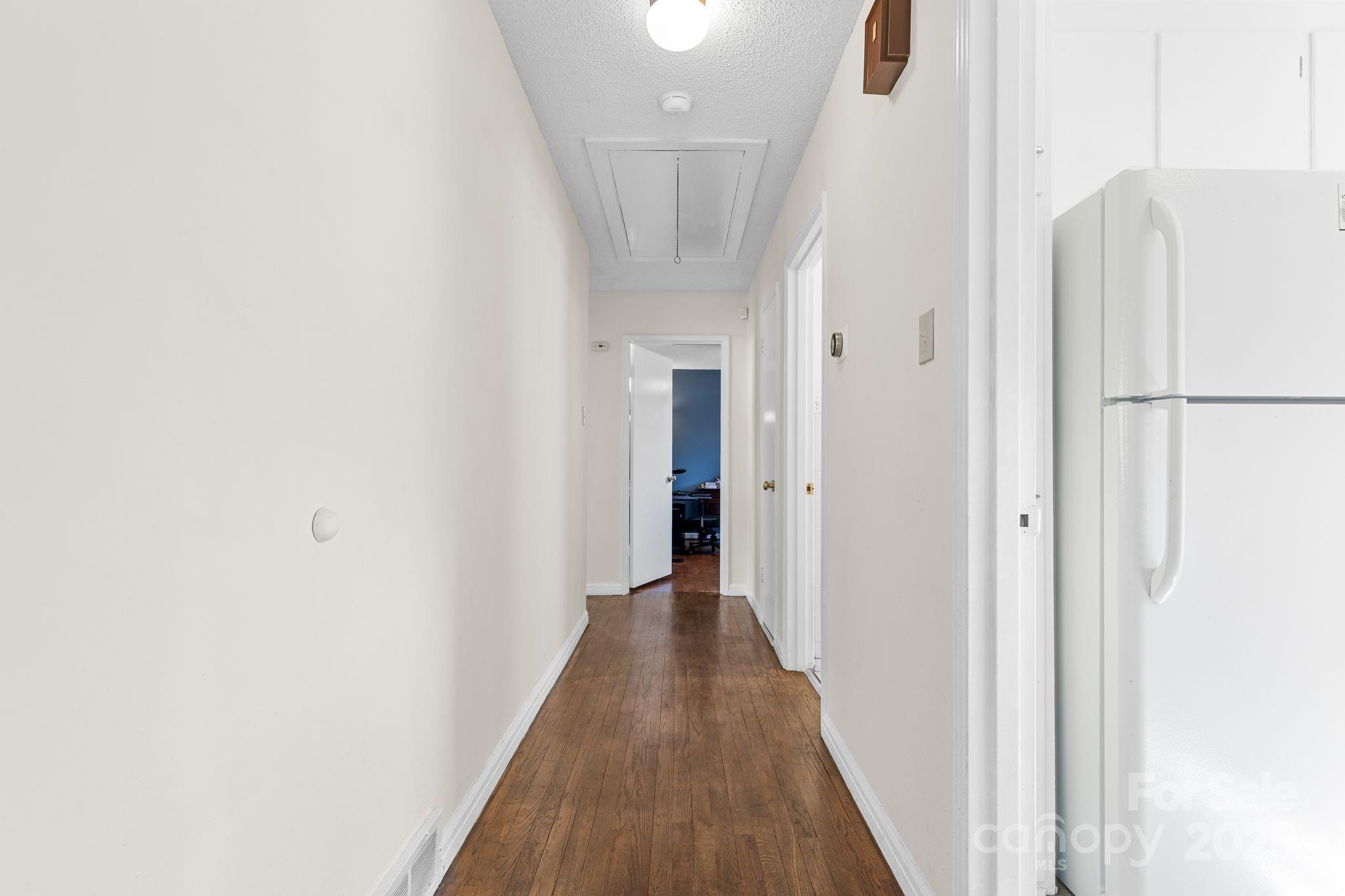 232 Hartness Road Statesville, NC 28677 - Photo 10 of 23 a view of a hallway with wooden floor