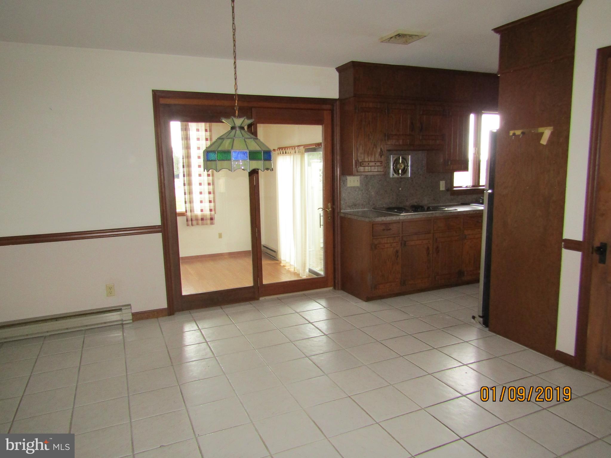 1295 Breneman Road Conestoga, PA 17516 - Photo 8 of 34 Kitchen area with sliding door to sunroom