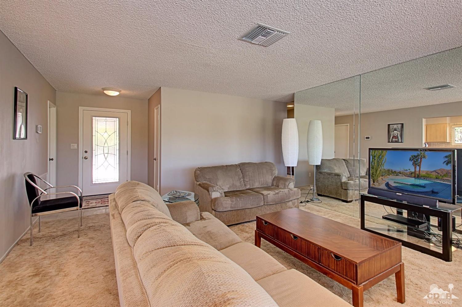 67860 Foothill Road Cathedral City, CA 92234 - Photo 16 of 30 a living room with furniture a flat screen tv and a window