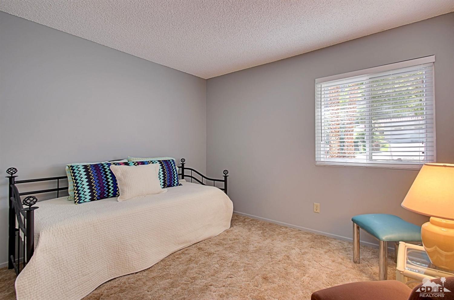 67860 Foothill Road Cathedral City, CA 92234 - Photo 26 of 30 a bedroom with a bed a chair and a window